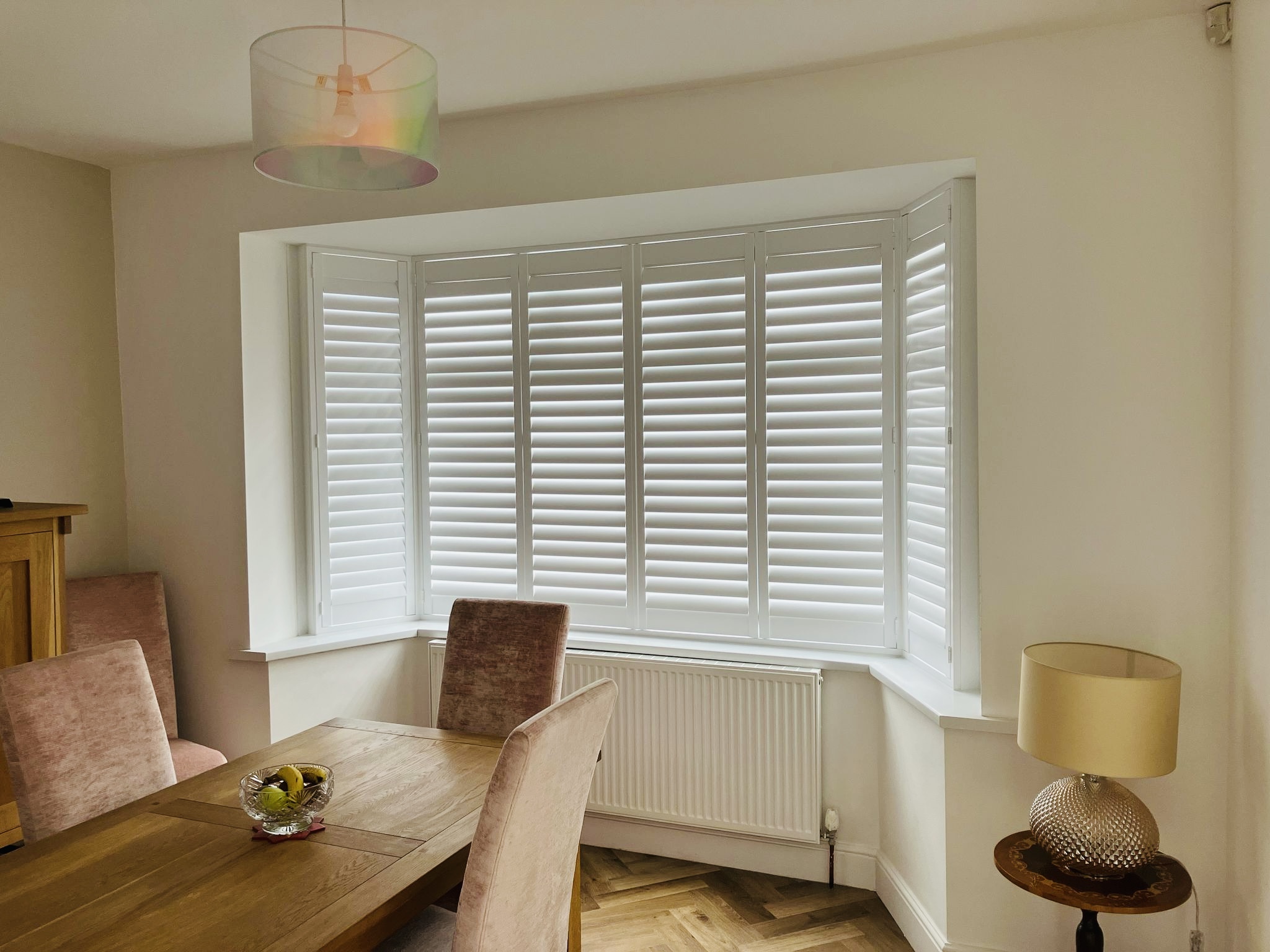 Bay window plantation shutters fitted in a London home